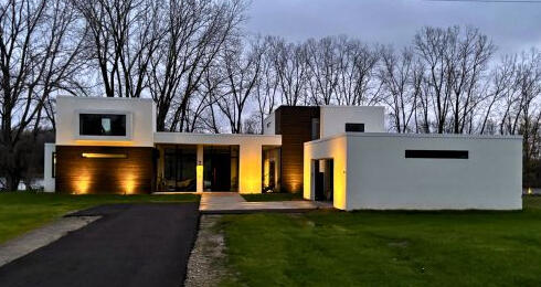 a white modern style home at dusk